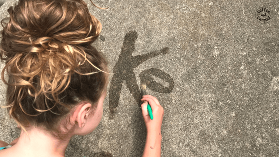 For a fun way to practice writing, have kids paint their letters or names with water on the ground. #summerfun #summerlearning #finemotorskills #summerslide #coffeeandcarpool