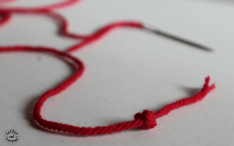 To start the beginning sew craft for kids, tie a knot in the end of the yarn. 